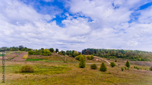 Aerial view of the landscape  hills  trees and blue sky with white clouds.