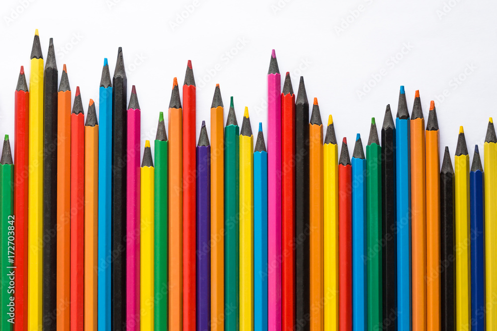 color pencils arranged downward trend on white background, top view. Set of multicolored pencils. color pencils arranged downward trend on white background, top view. Set of multicolored pencils.