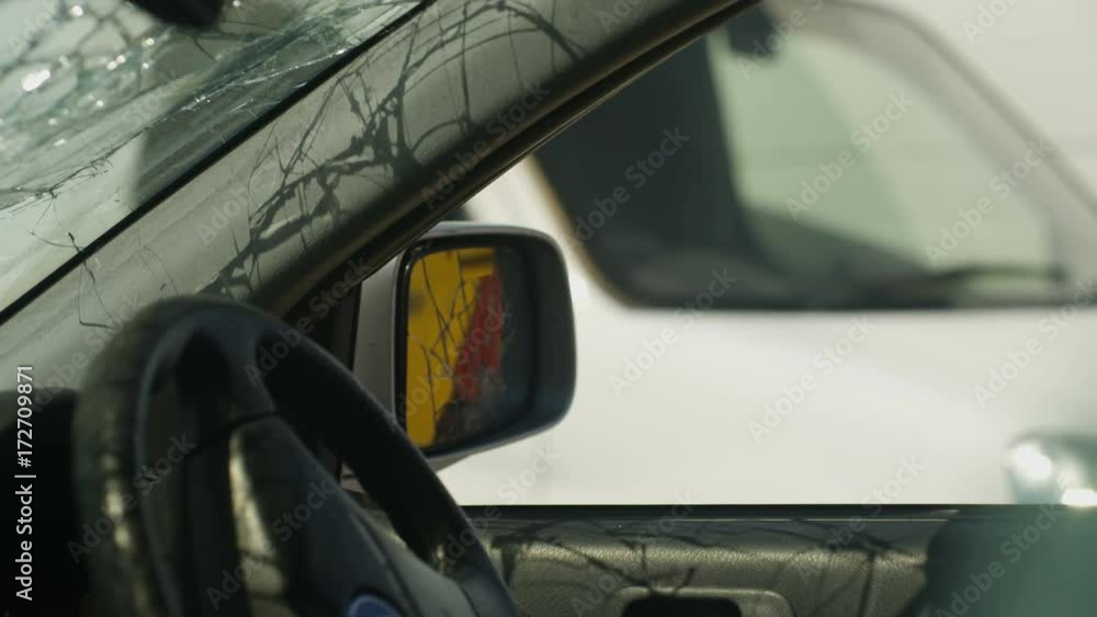 Aggressive astronaut with road rage vandalizing car mirror with baseball bat Aggressive astronaut with road rage vandalizing car mirror with baseball bat