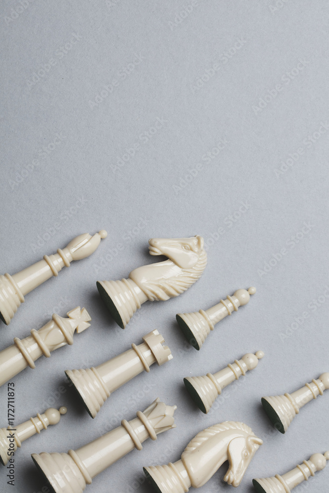 Chess game pieces on a grey background. Strategy concept Chess game pieces on a grey background. Strategy concept