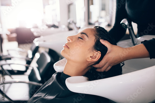 Konstfotografi Hairdresser washing hair of customer at salon