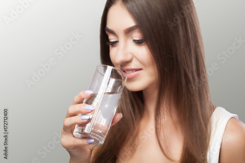 Healthy Lifestyle. Portrait Of Happy Smiling Young Woman With Glass Of Fresh Water. Healthcare. Drinks. Health, Beauty, Diet Concept. Healthy Eating.