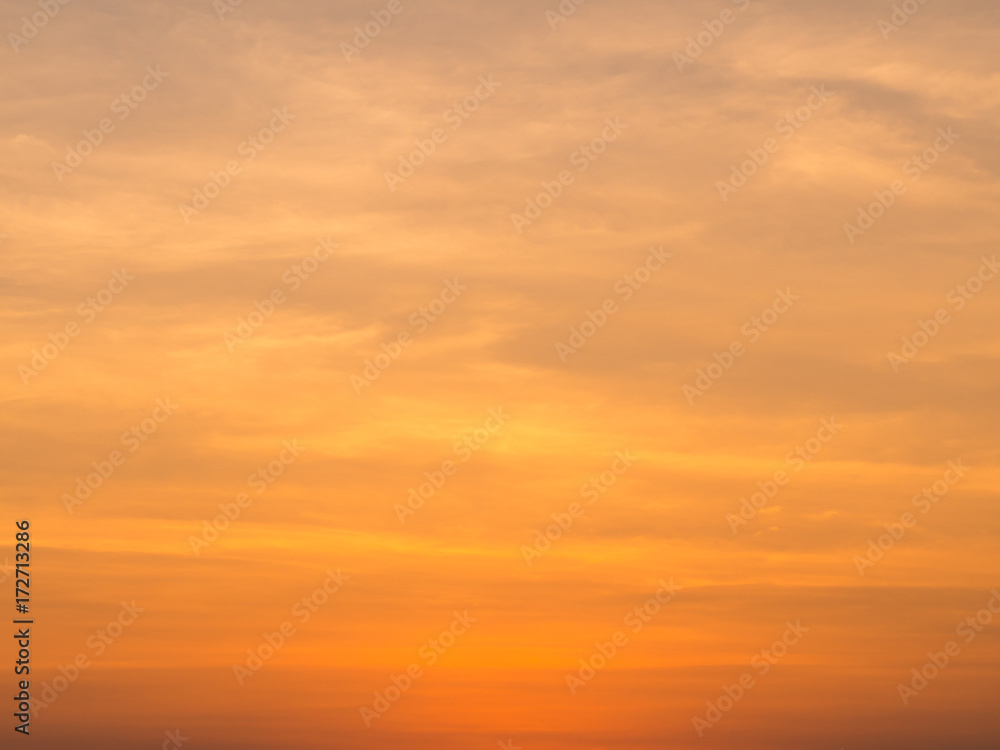 Abstract blur beautiful bright orange and golden sky at sunset sunrise for background.