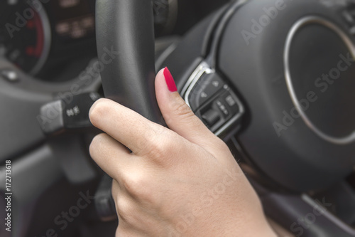 Young driver woman holding car wheel ready for journey