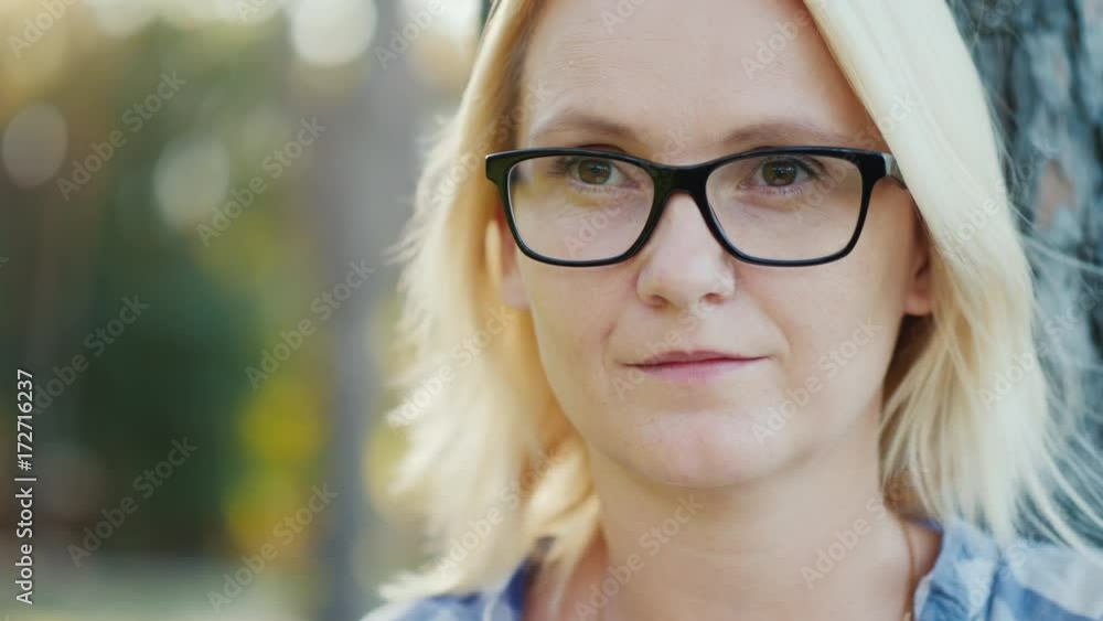 Portrait of a young caucasian woman. He dreams, looks ahead of the camera Portrait of a young caucasian woman. He dreams, looks ahead of the camera