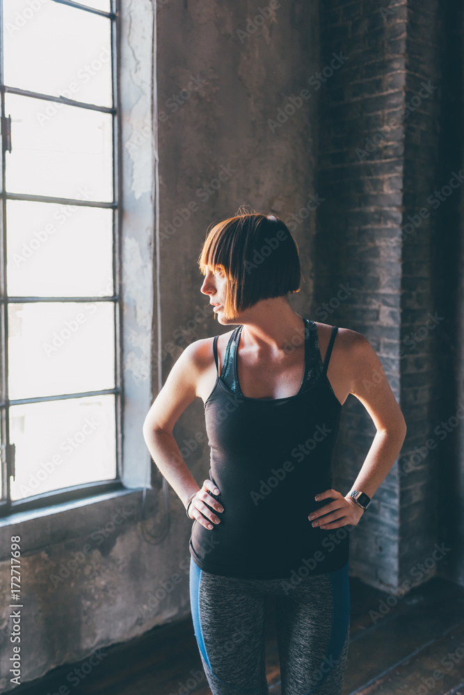 Fototapeta premium young model beautiful indoor looking sideway wearing sportive clothes - influencer, blogger, natural beauty concept