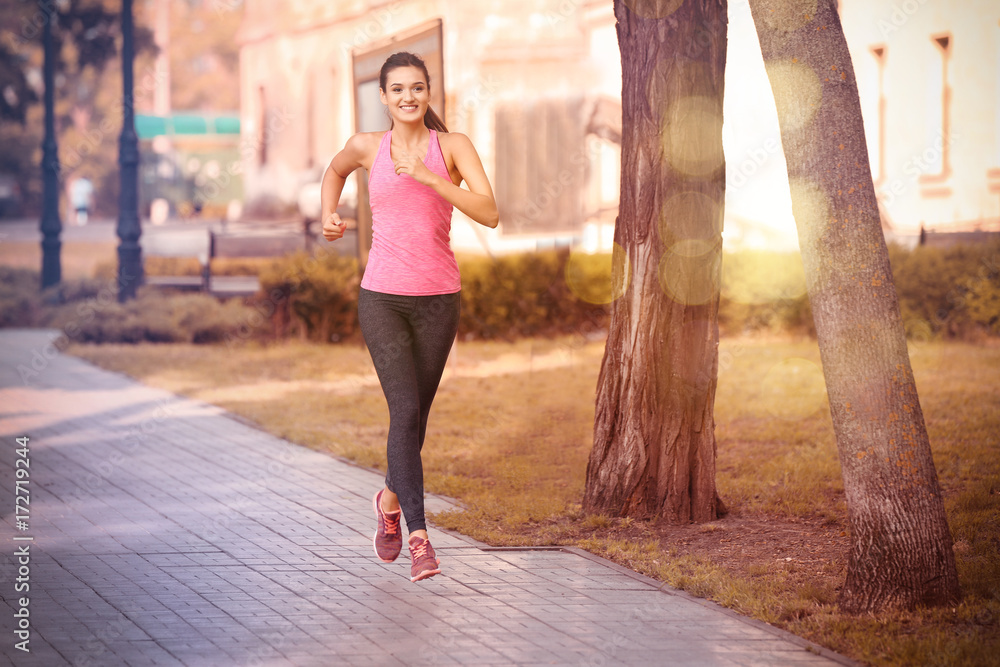 Young sporty woman running in park Young sporty woman running in park