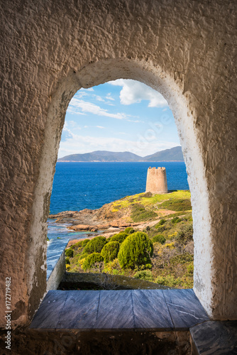 Billede på lærred View from an archway leading to the coast and an ancient watchtower