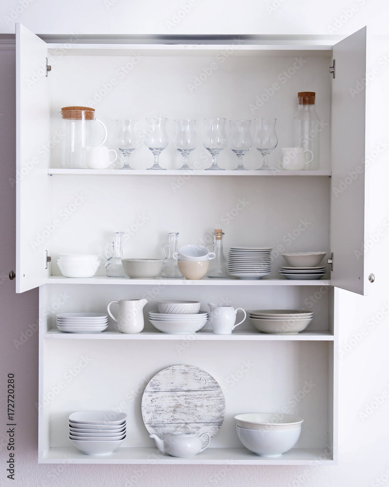 Fotografija Kitchen cupboard with different clean dinnerware