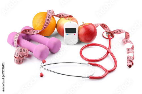 Composition with digital glucometer, stethoscope and dumbbells on white background. Diabetes concept