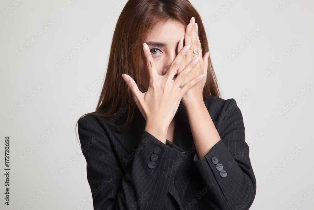 Beautiful young Asian woman peeking through fingers. Beautiful young Asian woman peeking through fingers.