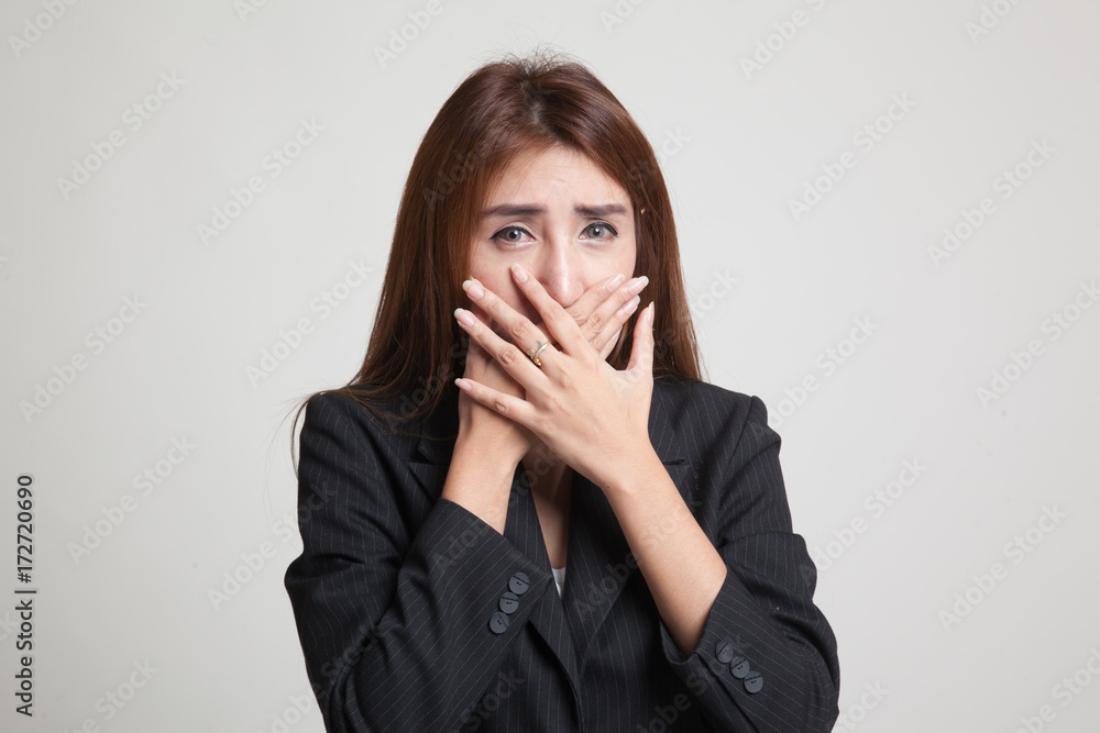 Beautiful young Asian woman close her mouth.