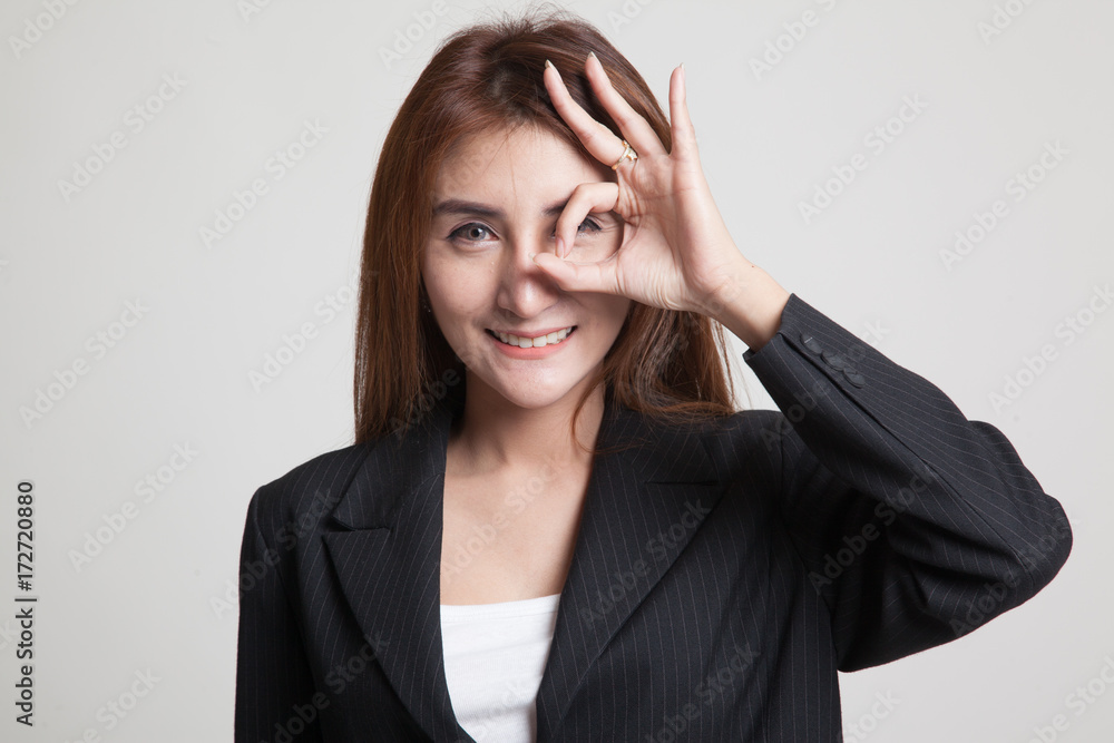 Beautiful young Asian woman show OK sign over her eye. Beautiful young Asian woman show OK sign over her eye.