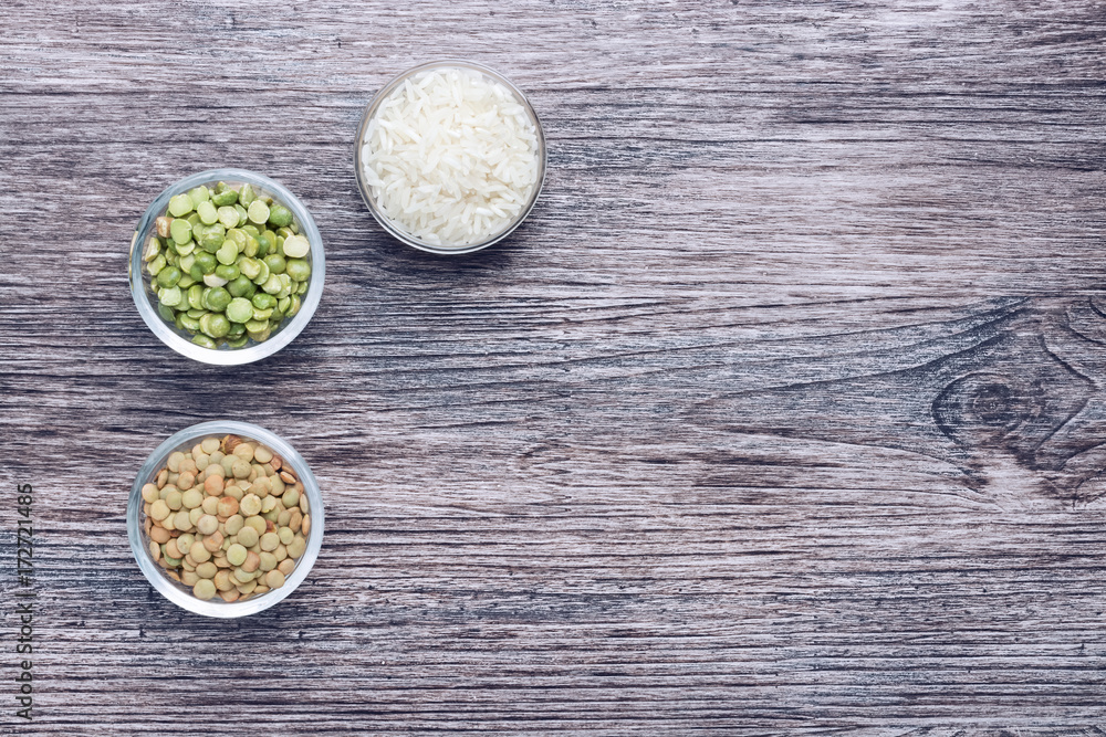 Collection of cereals in glass cups. Peas,rice and lentils on the wood surface. Collection of cereals in glass cups. Peas,rice and lentils on the wood surface.