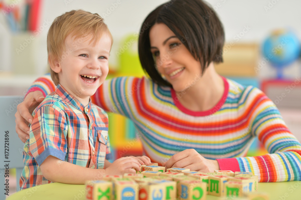 Fototapeta premium Young mother playing with son