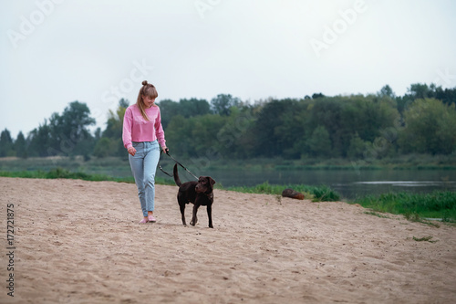 blonde girl smiling with dog Labrador