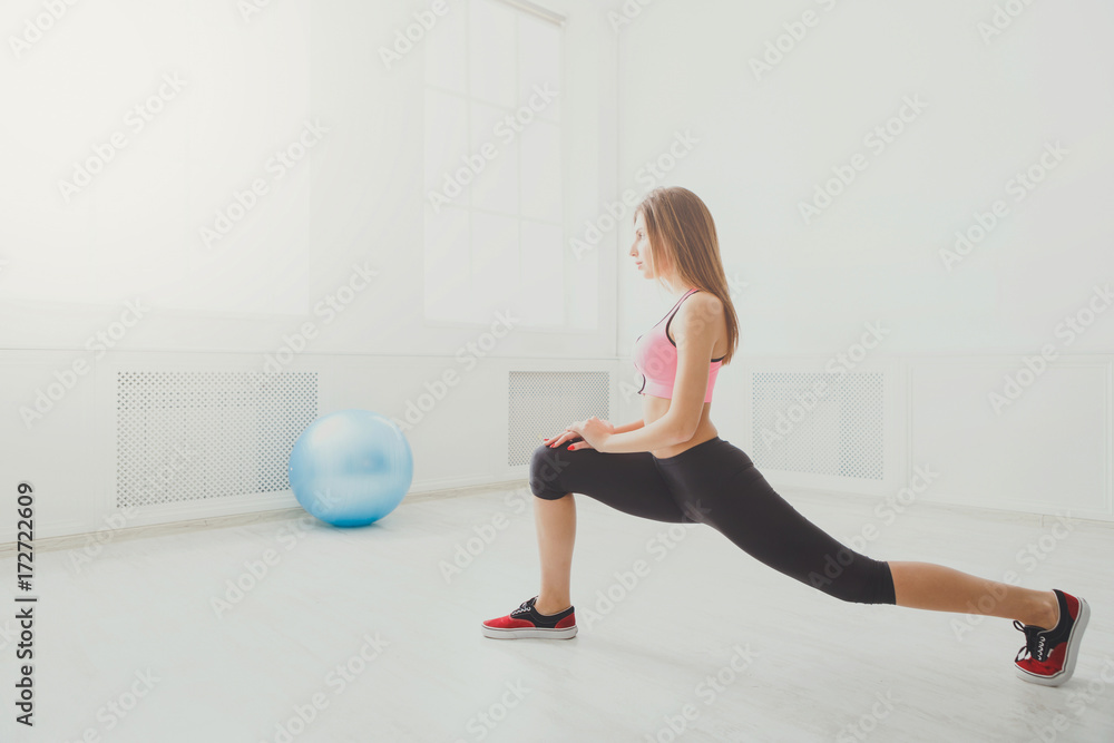 Fitness woman at stretching training indoors