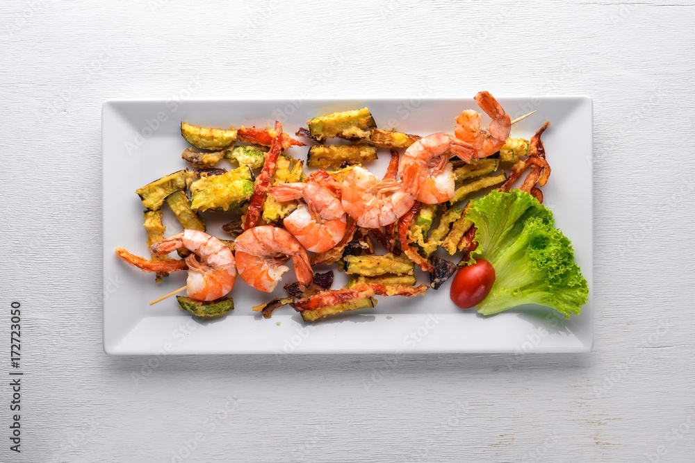 Roasted Royal Prawns with Grilled Vegetables. On a wooden background. Top view. Free space. Roasted Royal Prawns with Grilled Vegetables. On a wooden background. Top view. Free space.