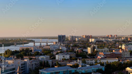 Modern cityscape near river during sunset