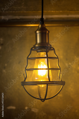 Decorative antique edison style light bulbs against brick wall background © kaiskynet