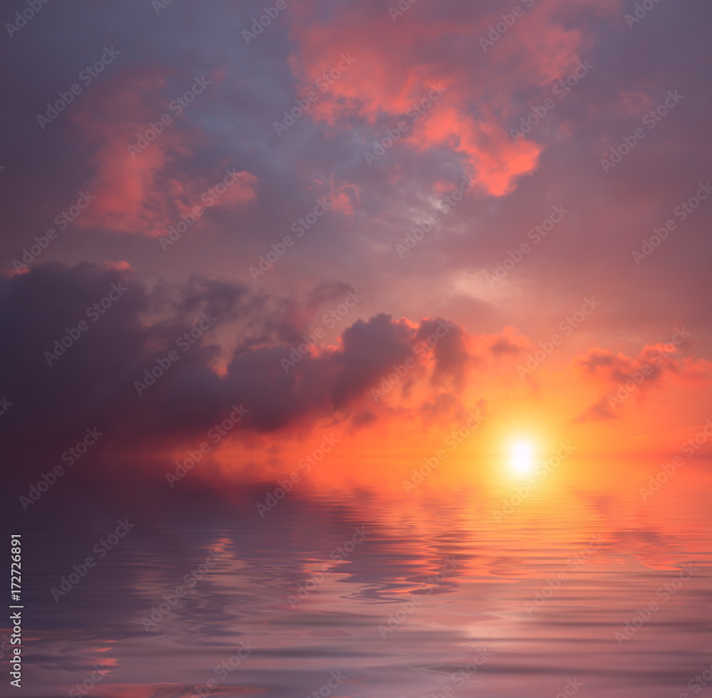 Storm clouds against the background of a blood-red sunset and a calm sea. Storm clouds against the background of a blood-red sunset and a calm sea.