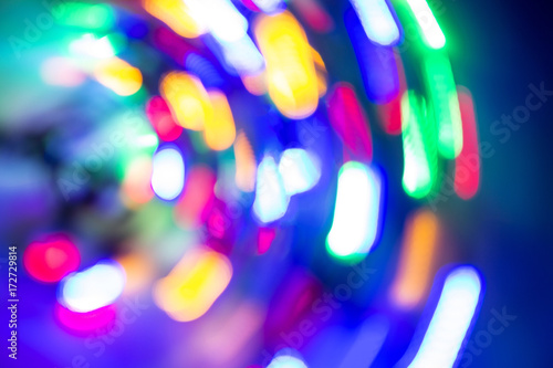 Light spots in motion. Lamps. Out of focus. Background. Different colors. In motion in a circle.