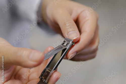 Woman Clipping Fingernail