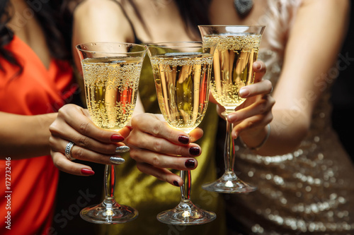 Women's hands with glasses of champagne. X-mas.