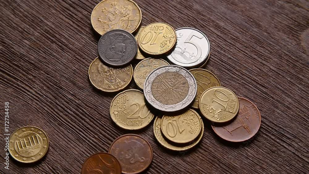 Bitcoins and other coins fall on the table Bitcoins and other coins fall on the table
