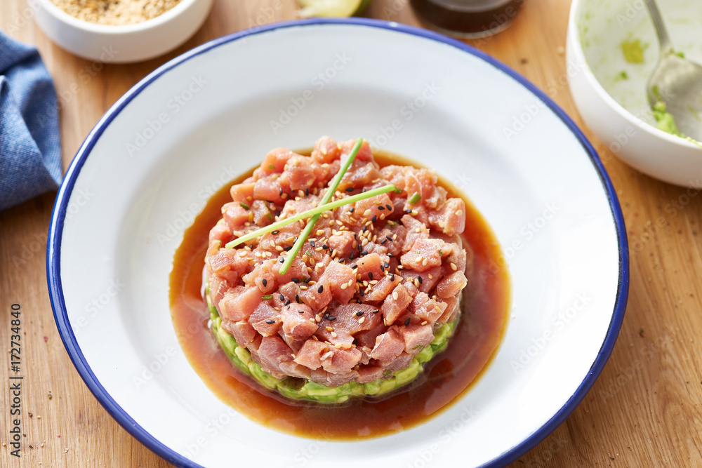 Served tuna tartare on plate with soy sauce Served tuna tartare on plate with soy sauce