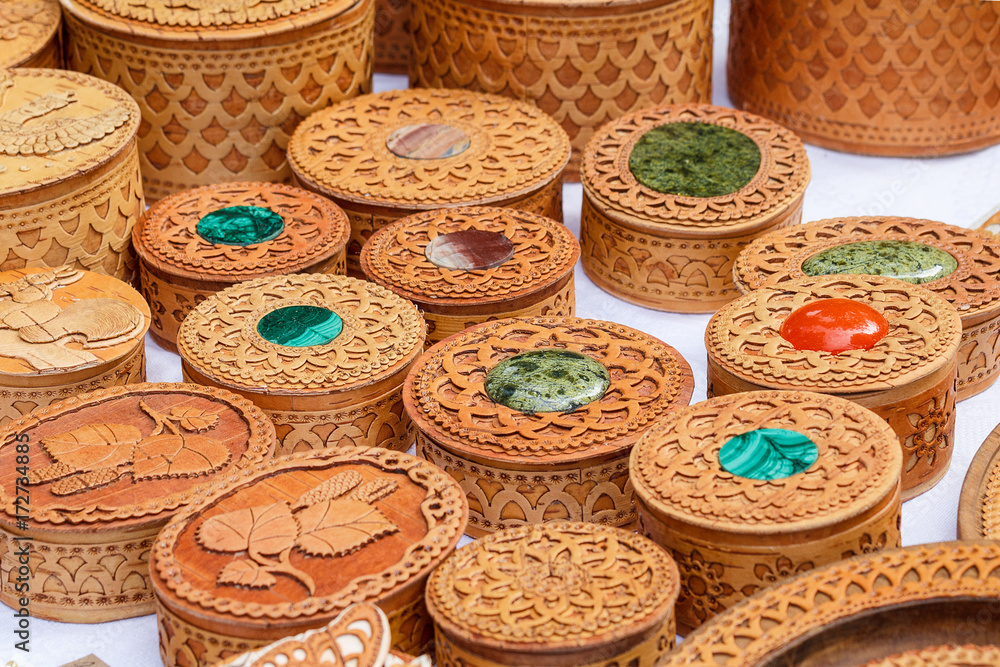 Handicrafts made of birch bark. Various carved boxes on the traditional town fair. Handicrafts made of birch bark. Various carved boxes on the traditional town fair.