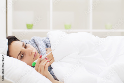 Fever And Cold. Portrait Of Beautiful Woman Caught Flu, Having Headache And High Temperature. Closeup Of Ill Girl Covered In Blanket, Feeling Sick Holding Thermometer. Health care. High Resolution
