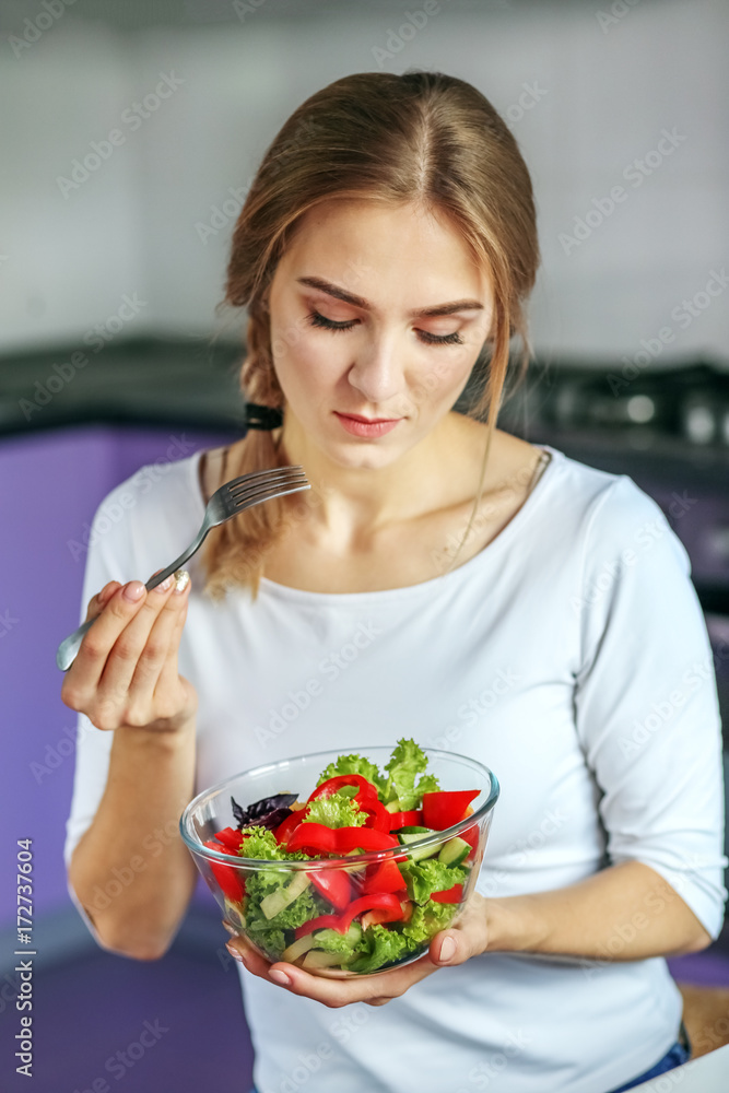 Young girl eats vegetable salad. The concept is healthy food, diet, vegetarianism, weight loss. Young girl eats vegetable salad. The concept is healthy food, diet, vegetarianism, weight loss.