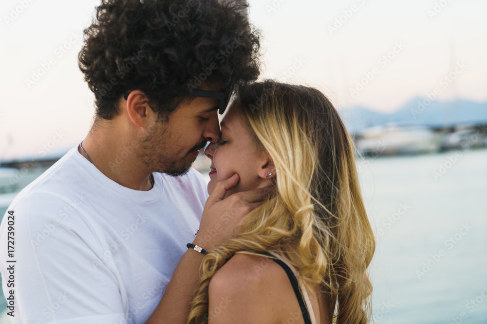 Young happy couple embracing on pier Young happy couple embracing on pier
