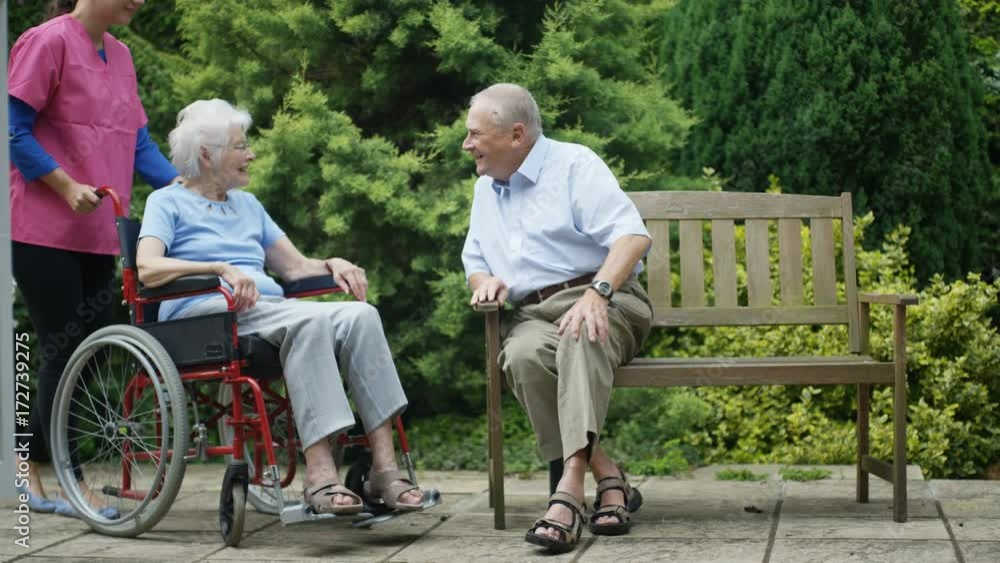 Cheerful elderly residents of nursing home spending time outdoors in the garden. Cheerful elderly residents of nursing home spending time outdoors in the garden.