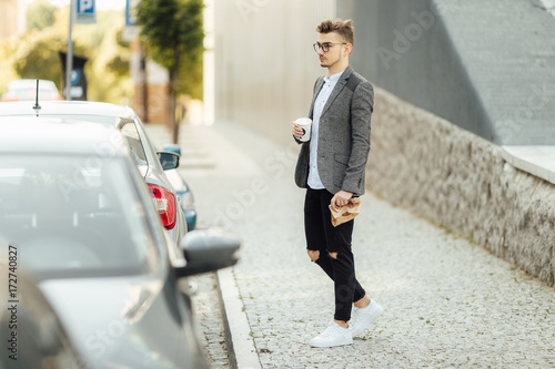 Young man walking on the street with blur background