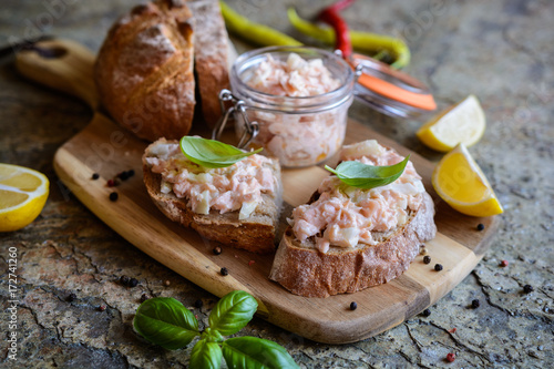 Salmon spread with cream cheese and onion on whole grain bread slices photo