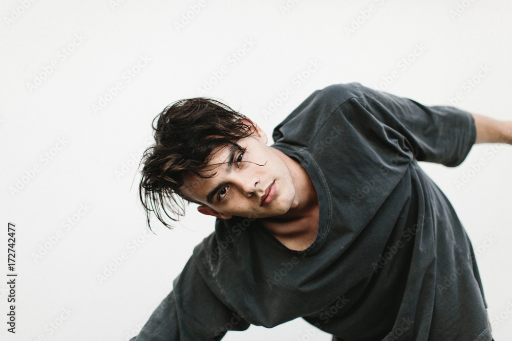 expressive portrait of man against white wall expressive portrait of man against white wall
