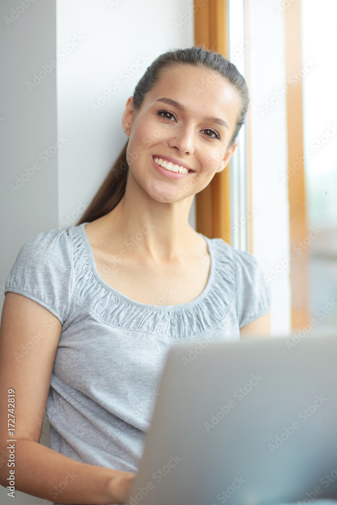 Young beautiful woman using a laptop computer at home. Young beautiful woman. Young beautiful woman using a laptop computer at home. Young beautiful woman.