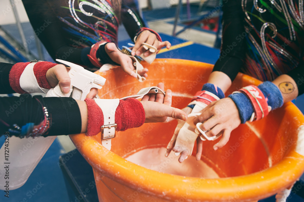 Gymnastics Girls Getting Chalk On Hands Before Practicing Bars Stock