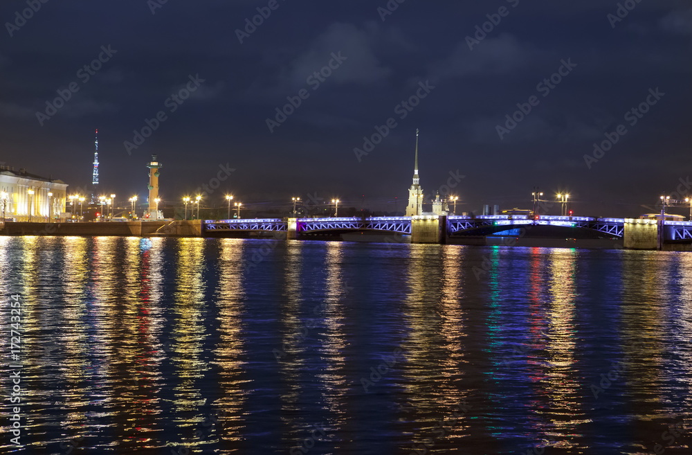Night view of the University embankment of St. Petersburg through the Neva River- Peter and Paul fortress,  Palace bridge, Vasilievsky island