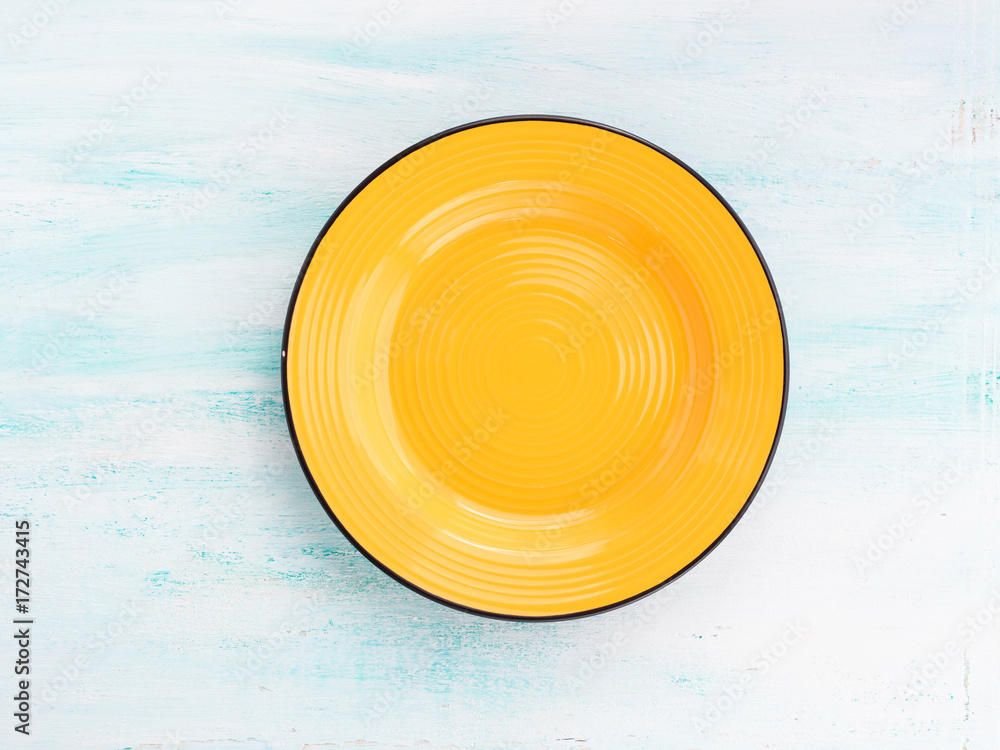 Pastel Color yellow ceramic plate dish top view background Stock Photo