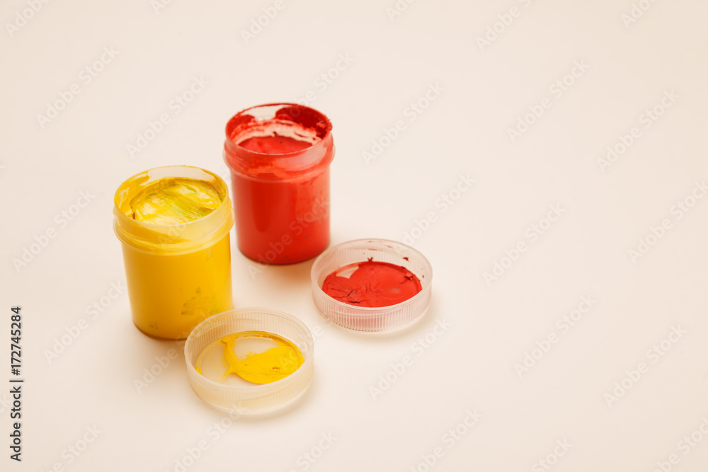 Open small paint jars on a table, selective focus