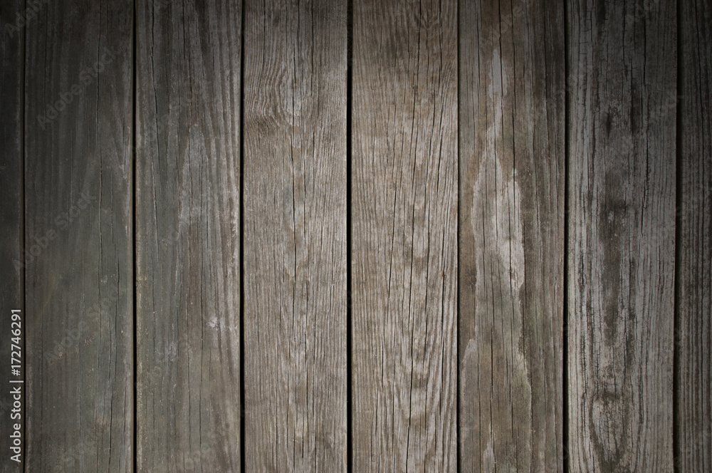 Weathered wooden planking background lit from above Weathered wooden planking background lit from above