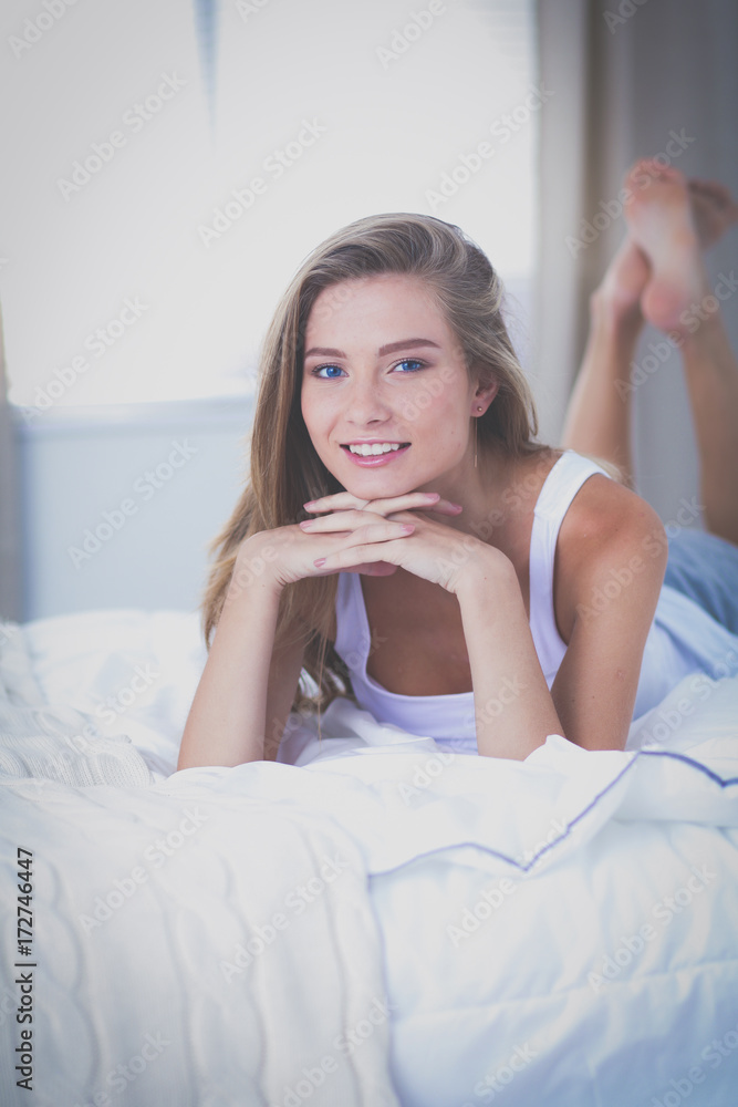 Pretty woman lying down on her bed at home . Pretty woman Pretty woman lying down on her bed at home . Pretty woman