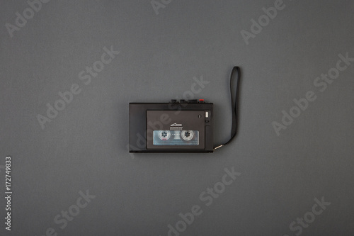 Top view of miniature vintage tape recorder on grey color background,copy space photo