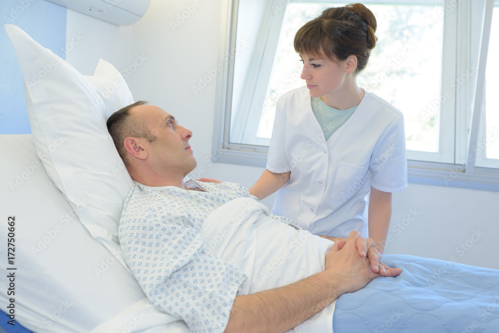 male patient talking to female nurse in emergency room male patient talking to female nurse in emergency room