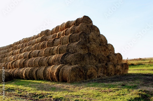 The pyramid is composed of hay balls in the rays of sunset.