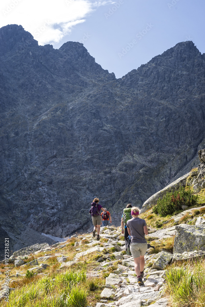 Tourists hiking on a mountain trail
