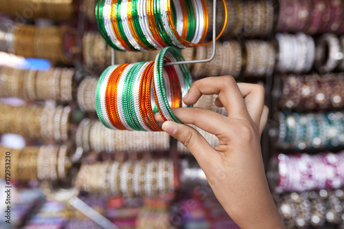 Teenage girl holding colorful bangles photo